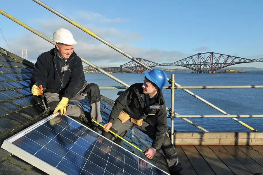 Solar Panels Being Fitted Onto Roof