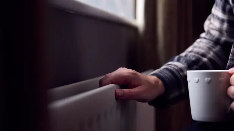 Man With Hand On Radiator