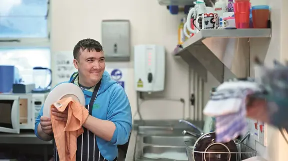 Man Dries Pots In Kitchen