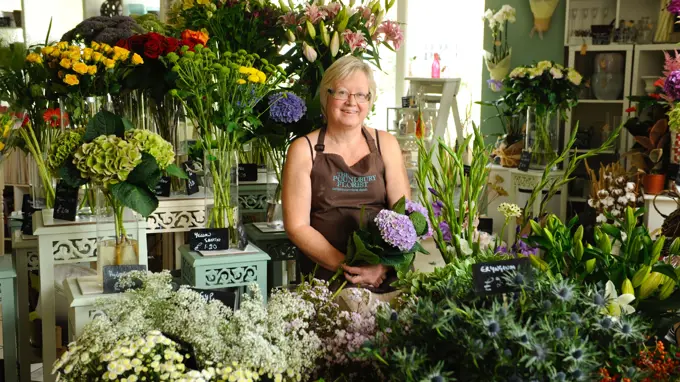 Florist In Shop With Flowers