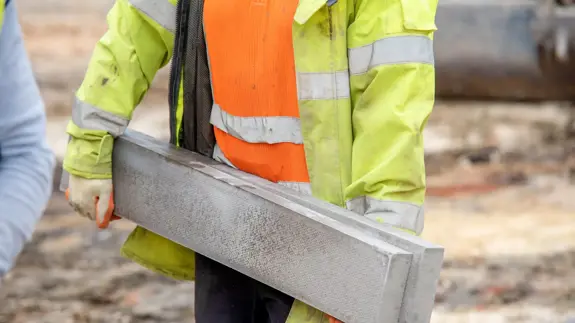 Construction Worker Carrying Concrete