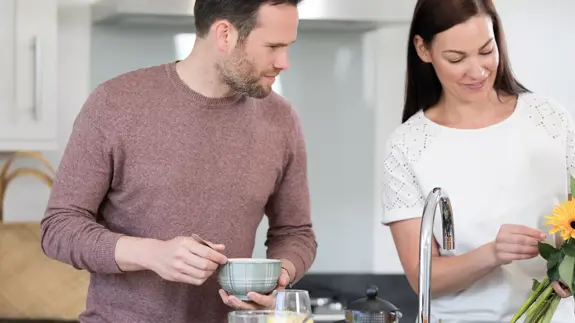 Man And Woman Stood In Kitchen