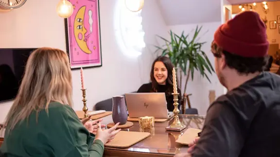 People Sat At Table Talking 2