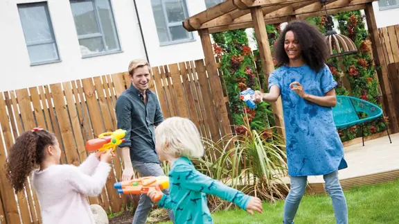 Family Playing In Garden